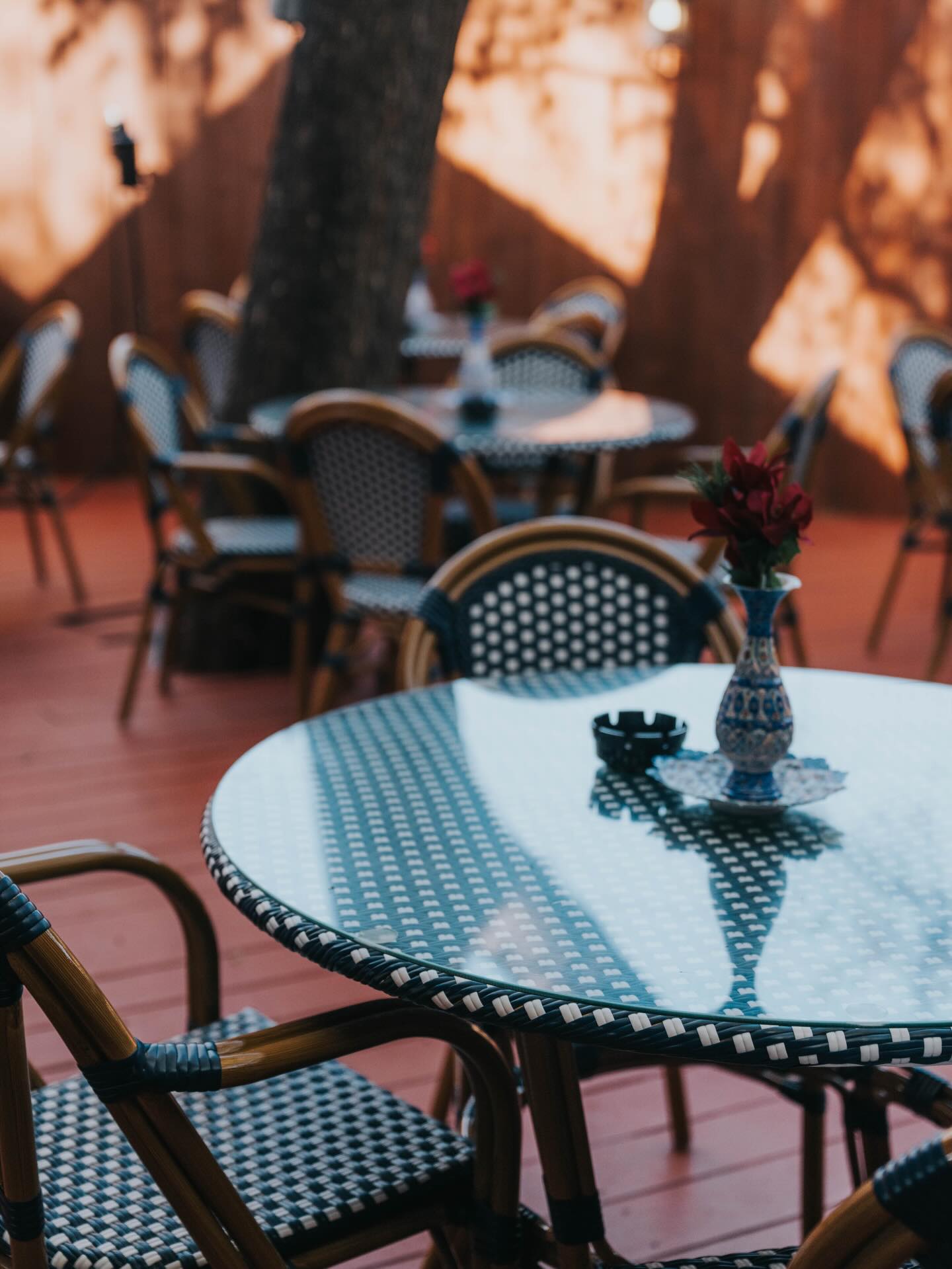 Sunlit courtyard patio with mosaic tables at Sip Haus Red River